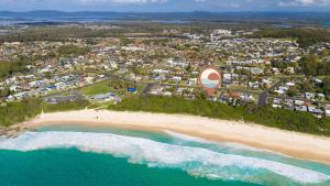 an aerial view of a beach with a resort at Beachfront Escape in Forster