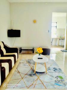 a living room with a couch and a table at Qalya Homestay 2 @ Kota Bharu in Kota Bharu