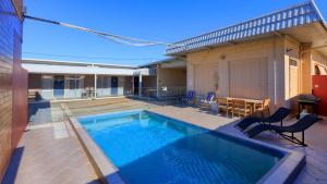 a large swimming pool in a yard with a house at Silver Haven Motor Inn in Broken Hill