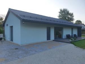 a white garage with a pitched roof at Rukkilille majutus in Herjava