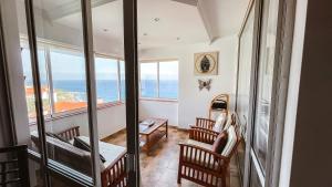 a room with a view of the ocean at Reis Magos Beach Caniço Sea line Apartment in Caniço