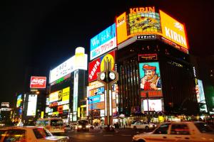 a busy city street at night with cars and signs at Meteor Shower in Sapporo