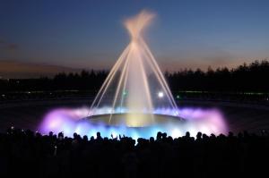 a crowd of people watching a stage with a cross on top at Meteor Shower in Sapporo