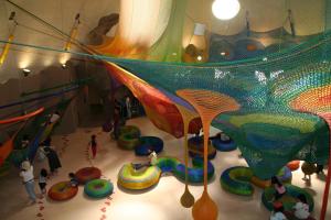 an indoor playground with people playing on a slide at Meteor Shower in Sapporo