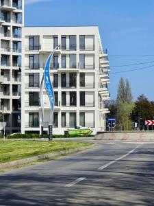 a building with a blue and white sculpture in front of it at OXYGEN NEPTUN BY BOUTIQUE C5 in Neptun