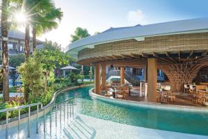 a pool at a resort with a pavilion at Marriott’s Bali Nusa Dua Gardens in Nusa Dua