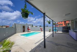 a house with a swimming pool with a potted plant at The Rise South Coast Rental by On Point Property Management in Christ Church