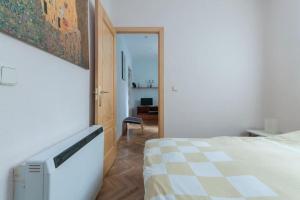 a bedroom with a bed and a room with a chair at Precioso Apartamento in Madrid