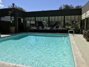 a swimming pool in a yard with a patio at The Morgan Hotel San Simeon in San Simeon