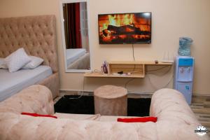 a living room with a couch and a fireplace at Denverwing Homes in Eldoret