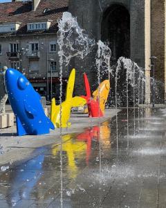 a water fountain in the middle of a city at Le Jardin des Caps, proche mer et port in Calais