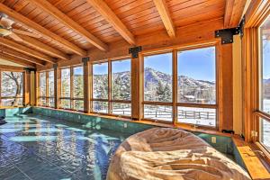 a swimming pool with a bed in a room with windows at Mountaineer Manor in Glenwood Springs