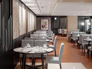 a dining room with tables and chairs and a table and chairsktop at Windsor Hotel Taichung in Taichung