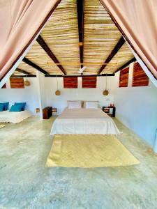 a bedroom with a bed in a large room at El Eden Escondido in Puerto Escondido