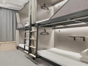 a bedroom with two bunk beds in a room at Sifang Space Hostel Xi'an - Xi'an TIYUCHANG metro station Line2 in Xi'an