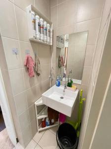 a small bathroom with a sink and a mirror at Sunway Geo Suite-Linked BRT-Medical in Petaling Jaya