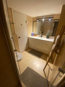 a bathroom with a sink and a toilet and a mirror at spacious real two bedrooms at the daniel hotel in Herzliya