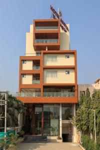 a tall building with a lot of windows at Hotel Aditya Mansingh Inn in Somnath