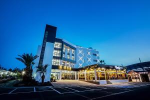 a large building with a parking lot in front of it at The Seri Resort in Seogwipo