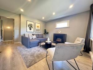 a living room with a couch and a fireplace at Spacious 4 BR House in Park Drive in Vancouver