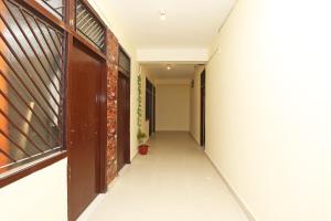 an empty hallway with a brick wall and a door at Flagship Hotel Dream Connect in Ghaziabad