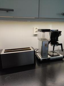 a kitchen with a coffee maker and a toaster at Maggala apartments in Utsjoki