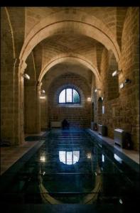 a large swimming pool in a stone building with a window at Come nelle favole in Taranto