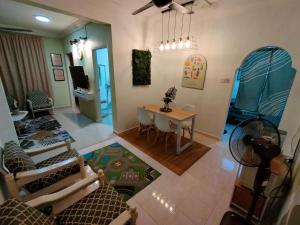 an overhead view of a living room with a table and chairs at Mini Green Homestay in Kulai