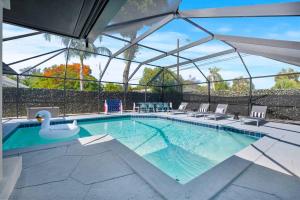 a swimming pool with chairs and a swan on it at Casa Grandè in Clearwater