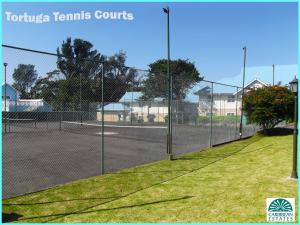 a tennis court with a chain link fence at Caribbean Estates Montego Bay 05 in Port Edward