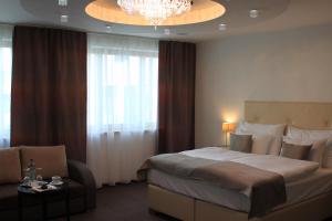 Postel nebo postele na pokoji v ubytování Danubia Gate Hotel
