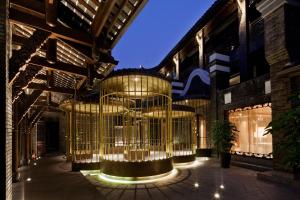 a building with a large chandelier hanging from the ceiling at Diaoyutai Boutique Hotel Chengdu in Chengdu