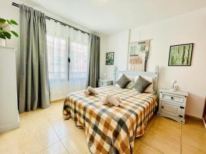 A bed or beds in a room at Rooftop Pool Apartment Corralejo