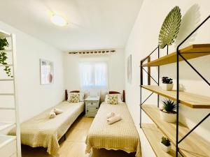A bed or beds in a room at Rooftop Pool Apartment Corralejo
