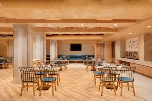 a large room with tables and chairs and a stage at Lemon Tree Hotel Bhopal in Bhopal