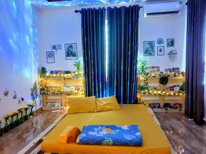 a bedroom with a bed in a room with blue curtains at Mihome in Hai Phong