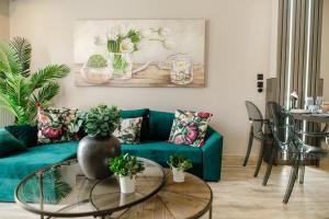a living room with a green couch and a table at PELAGIO APARTMENT 1 in Alexandroupoli