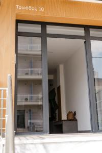 a large window of a building with a balcony at PELAGIO APARTMENT 1 in Alexandroupoli +151 photos
