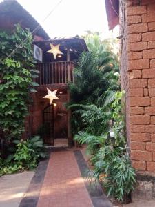 a brick building with a gate with stars on it at Sea Breeze Village, Baga Goa in Calangute