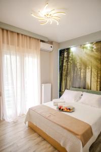 a bedroom with a large bed with a large window at PELAGIO APARTMENT 1 in Alexandroupoli