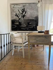 a desk and a chair in a room with a painting at Kydippi Kea Villa in Korissia