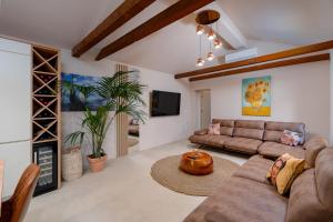 a living room with a couch and a table at Villa Slatina near Zrce beach in Novalja