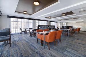 a large room with tables and chairs and windows at Holiday Inn Express & Suites - Kansas City KU Medical Center by IHG in Kansas City
