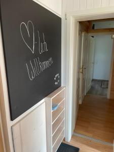 a hallway with a chalkboard wall in a house at Oyer Ferienhaus in Oy-Mittelberg