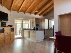 a large kitchen with wooden cabinets and a kitchen island at Oyer Ferienhaus in Oy-Mittelberg