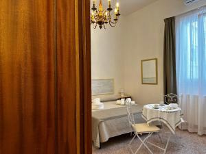 a bedroom with a bed with a table and a window at le stanze di galloLizio in Gallipoli