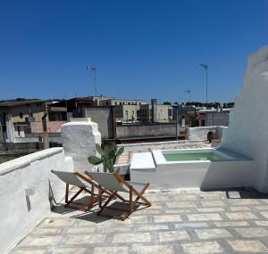 a patio with a table and chairs on a roof at L’Edicola Votiva in Casarano