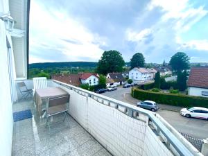 a balcony with a table and a view of a street at Schwarzwald Appartment in Freudenstadt