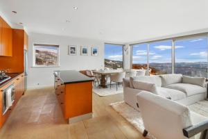 a kitchen and living room with a couch and a table at MarkII 4 West in Mount Buller