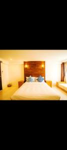 a bedroom with a large bed and a couch at Pai Woodland Resort in Pai